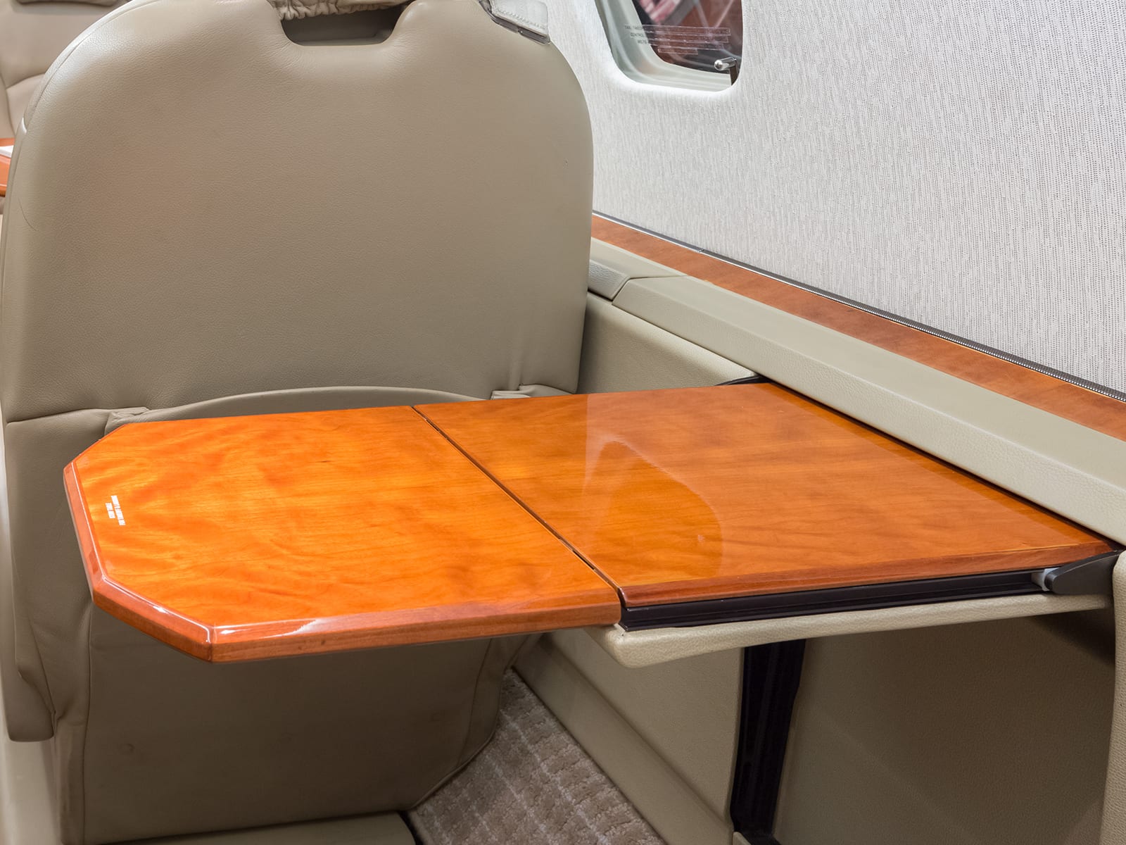 A fold out table in a Priority Jet aircraft